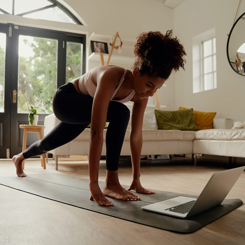 woman following online training workout video